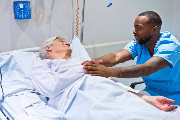 istock Smiling nurse consoling patient lying on gurney 1783972787