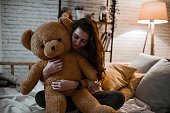 Female Feeling Safe While Embracing Teddy Bear To Fall Asleep