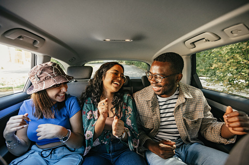 Group of friends having fun in the car