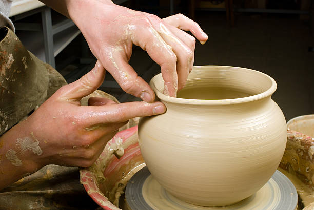 istock hands of a potter, creating an earthen jar 178397904