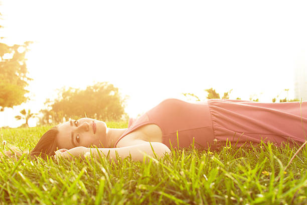 istock Beautiful girl lying in the grass 178397982