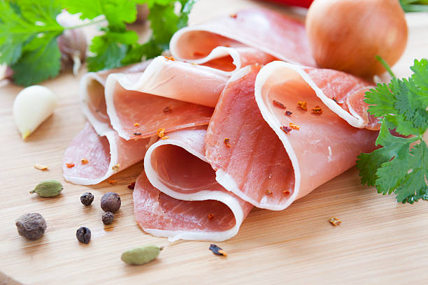 istock thin slices of ham on a wooden surface 178398037