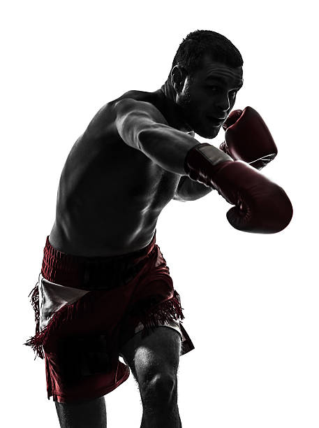 one man exercising thai boxing silhouette one caucasian man man exercising thai boxing in silhouette studio on white background boxing stock pictures, royalty-free photos & images