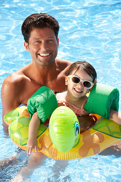 istock Father And Daughter Having Fun In Swimming Pool 178398385