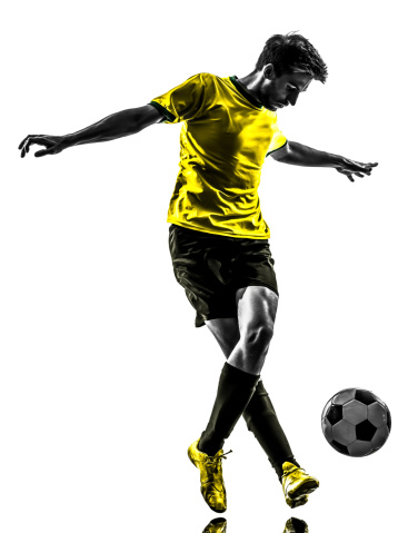 Soccer player in action on a professional arena full of spectators