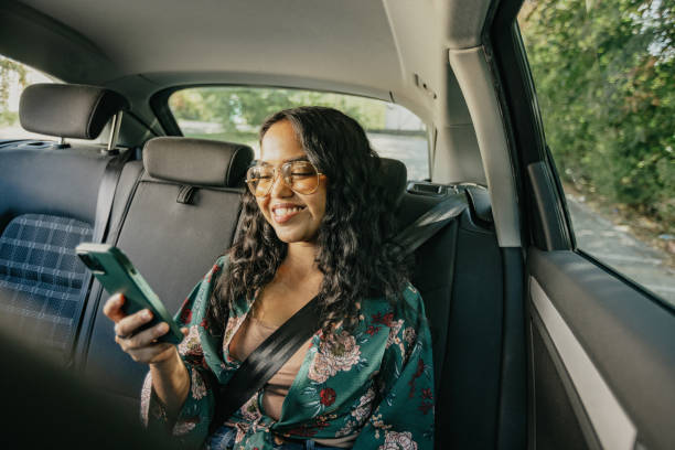 istock Young Indian woman using mobile phone in a car 1783985481