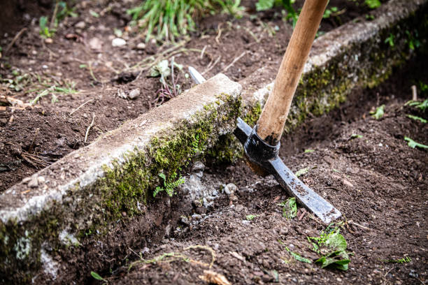 istock pickaxe in the garden, old kerbstone is dug up 1783987994