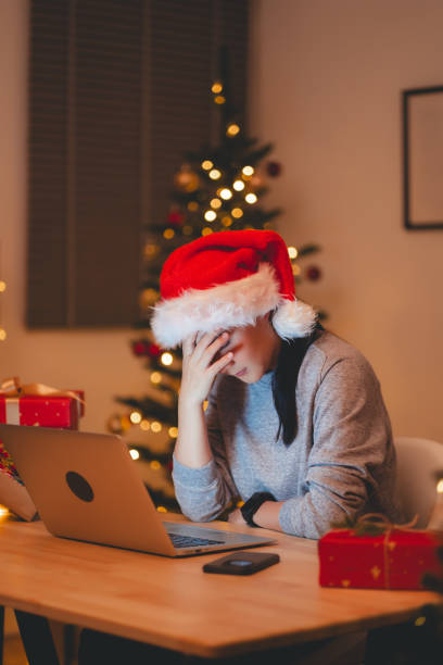 istock Asian woman have a problem with work, sitting at home office on Christmas day. 1783992492