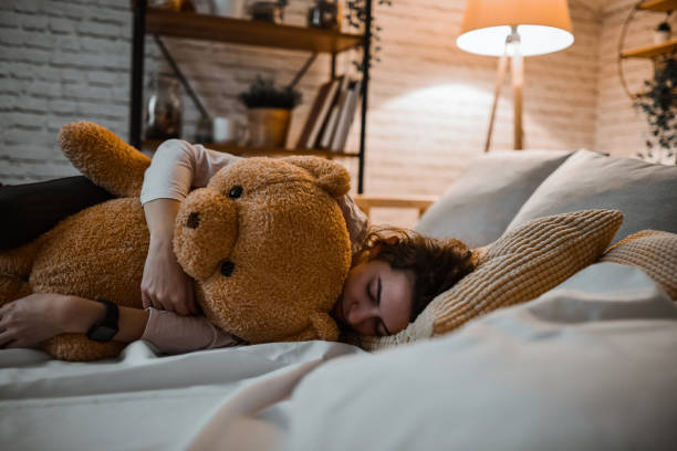 istock Stuffed Bear Providing Female With Warmth And Comfort While Sleeping 1783994151