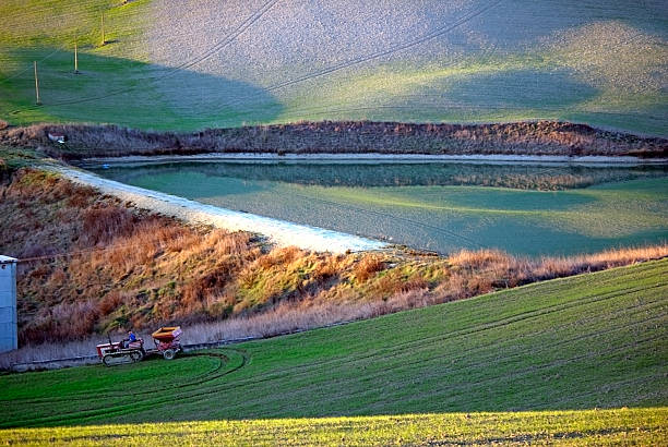 istock tractor working on green and yellow grass 178399488