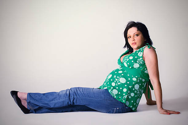 Pregnant woman sitting on a floor