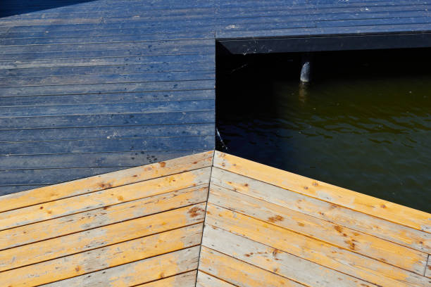 istock Photo a wooden floating bridge and water. 1783998753