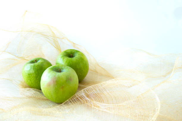 Top view of a green apple against a white background