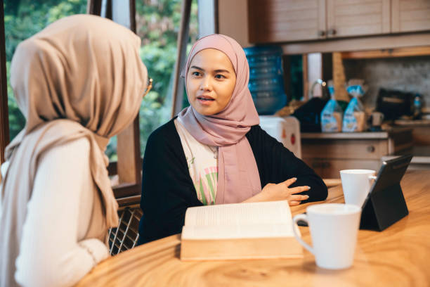 istock Two muslim Female Friends Studying Together Using A Laptop At The Kitchen Table 1784001721