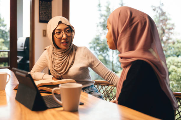 istock Two muslim Female Friends Studying Together Using A Laptop At The Kitchen Table 1784002040