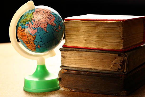 istock Pile of old books and globe 178400306