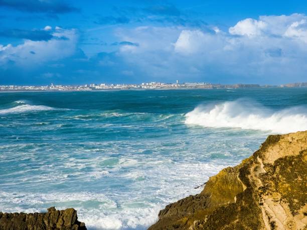 istock waves rolling on the rocks and around the shoreline, with blue skies overhead 1784012130