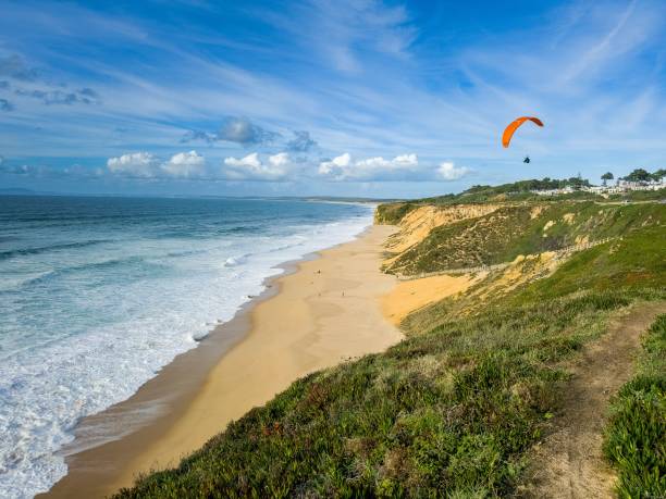 istock paragliders on the beach at the ocean shore by the cliff 1784013193