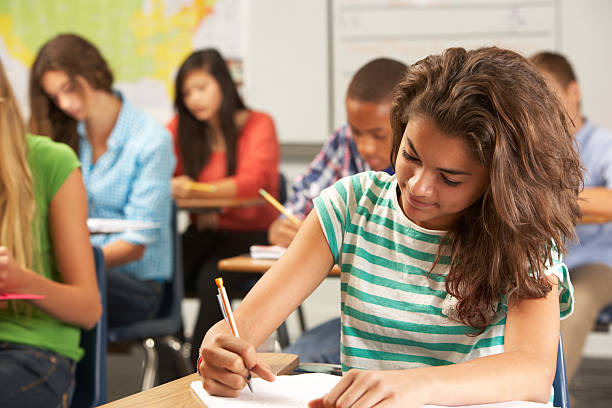 istock Female Pupil Studying At Desk In Classroom 178402698