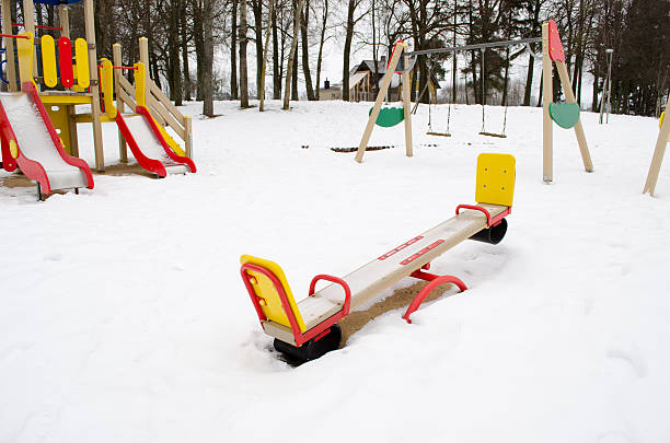 istock empty playground swing childhood snow winter 178402883