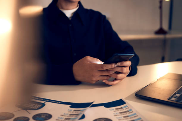 istock Hands, business woman and phone in office for texting, web browsing or social media. Technology, cellphone and female employee with mobile smartphone for networking or internet scrolling at night. 1784029242