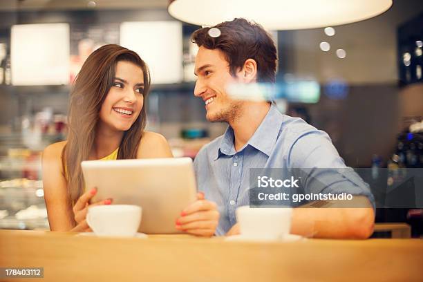 Flirting Couple In Cafe Using Digital Tablet Stock Photo - Download Image Now - Adult, Adults Only, Beautiful People