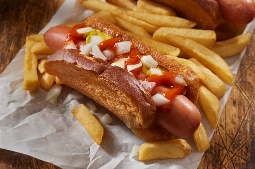 The Viral Deep fried White Bread Taco Dog with, Ketchup, Mustard, Onions and Fries.  Flatten slices of white bread, fold and use toothpicks to hold together than deep fry.