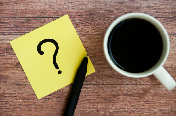 istock Top view of question mark on notepad with pen on coffee. Question and answer concept 1784043624