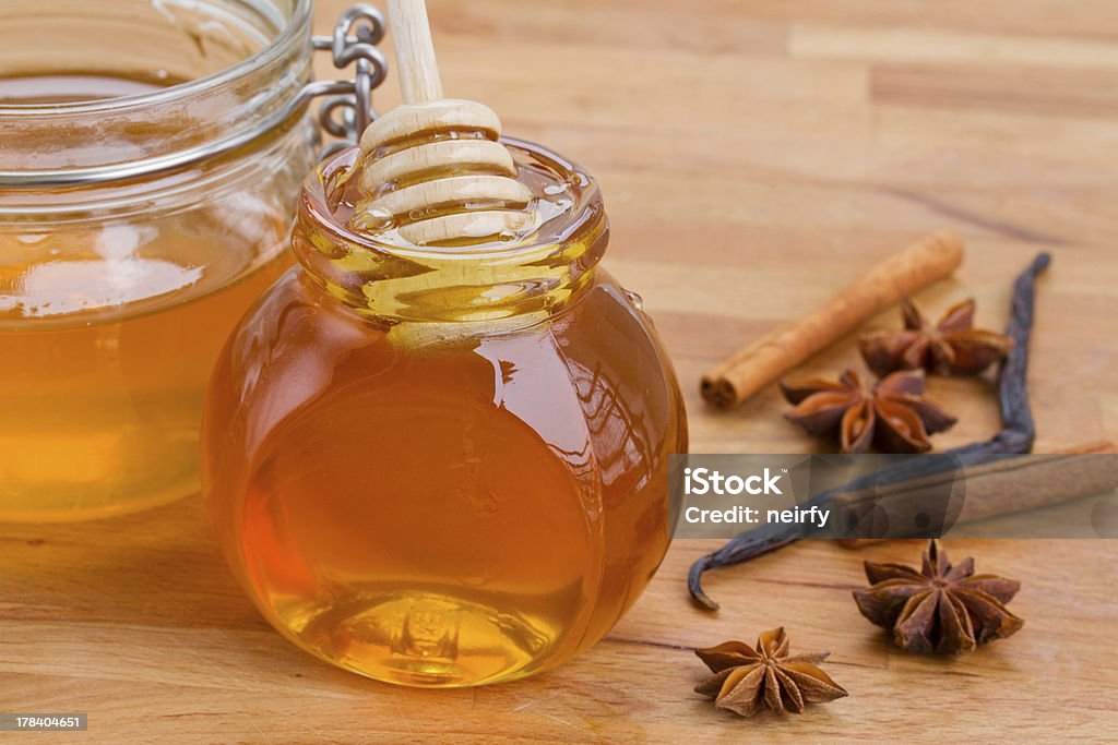 pots of honey and spices glass honey pots and spices on wooden table Anise Stock Photo