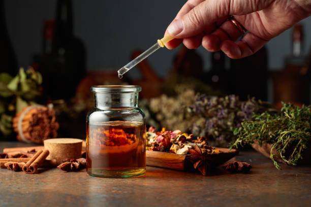 istock Dropping essential herbal tincture into a small glass bottle. 1784051358