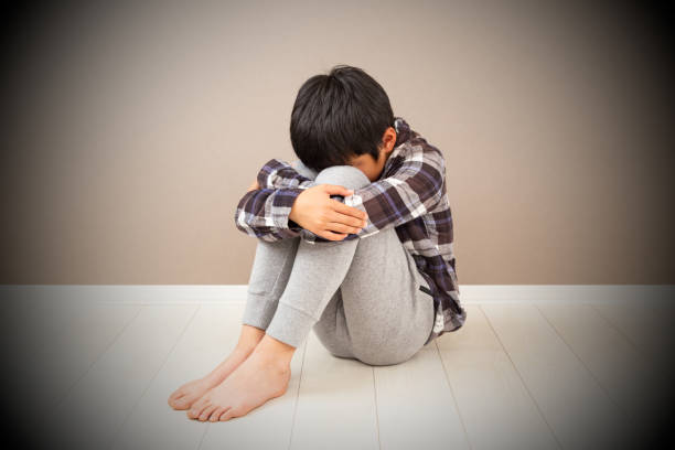 istock A boy feeling depressed in his room. 1784051915