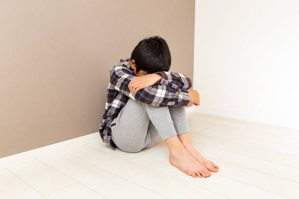 istock A boy feeling depressed in his room. 1784055381