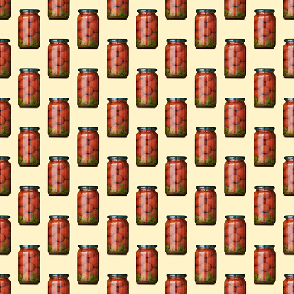 Square seamless pattern of glass jars with canned tomatoes is isolated on yellow background.