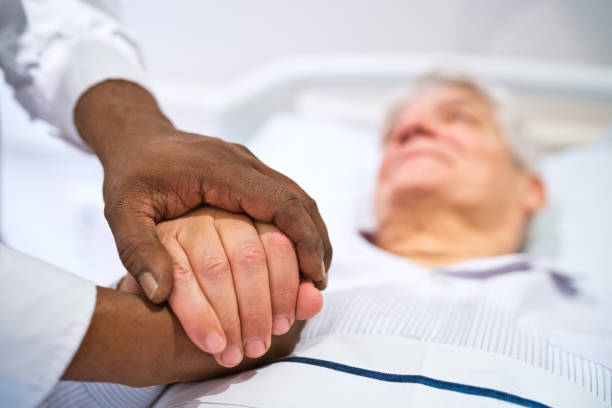 istock Doctor consoling male patient lying on bed 1784056183