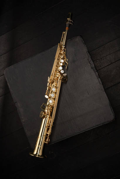 istock Straight Golden Saxophone on a black cube on a black background 1784056240