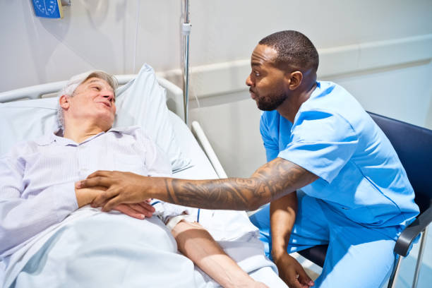 istock Smiling nurse consoling patient lying on gurney 1784061220