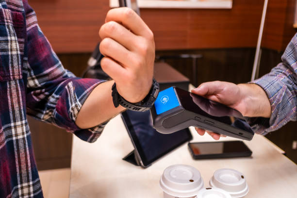 istock Customer makes a payment with a smart watch at a small retailer 1784067856