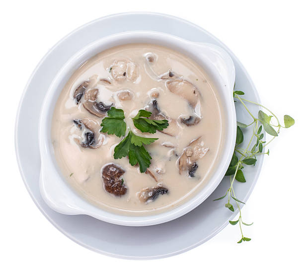 Fresh Mushroom Soup (on white) Fresh Mushroom Soup topped with some herbs isolated on white background cream soup stock pictures, royalty-free photos & images