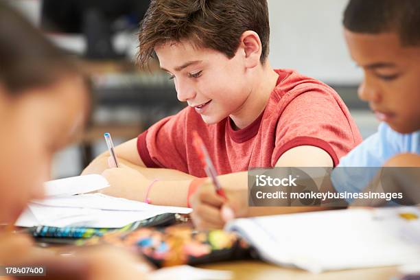 Pupils Studying At Desks In Classroom Stock Photo - Download Image Now - 10-11 Years, African Ethnicity, African-American Ethnicity