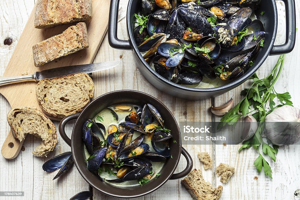 Mussels meal served with bread by the sea Mussels meal served with bread by the sea. Animal Shell Stock Photo