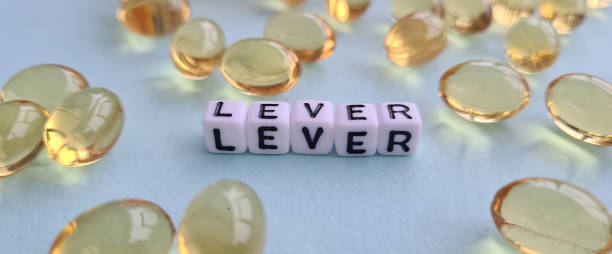 istock Liver problems with medical pills and liver closeup 1784078618