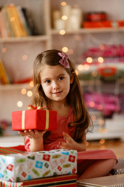 istock Cheerful little girl holding Christmas present 1784081484