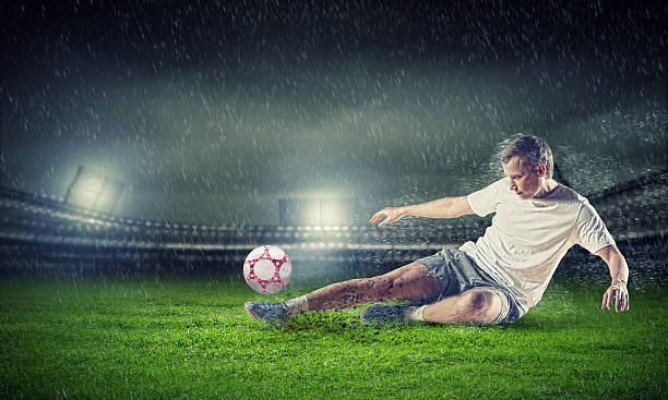 istock football player striking the ball 178408195