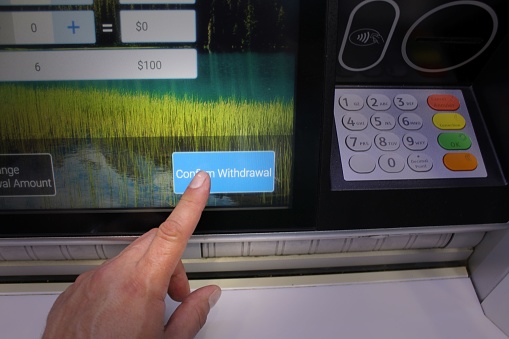 Vancouver, Canada – July 25, 2023: A hand gesturing towards a ticket machine sign, emphasizing the importance of purchasing a ticket before moving forward