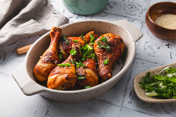 istock Chicken drumsticks with sesame seeds, Asian cooked chicken on the table 1784087156