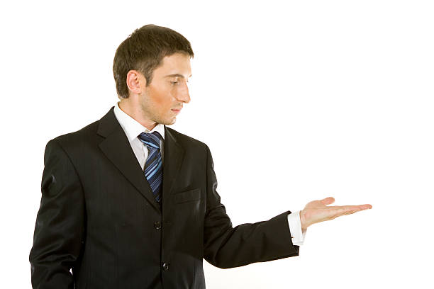 istock Young man in a suit showing something 178408870