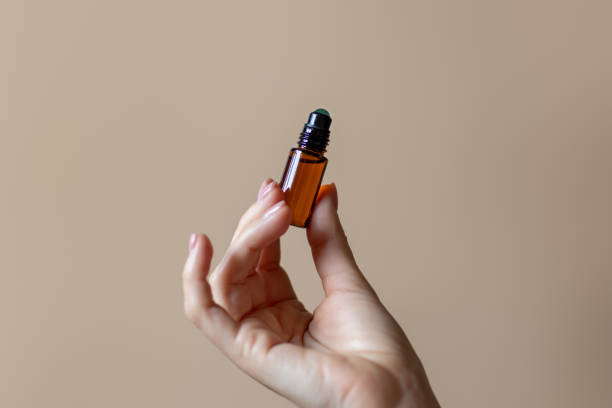 istock Aroma rollerball with natural aromaoil in woman hand on plain background 1784092719