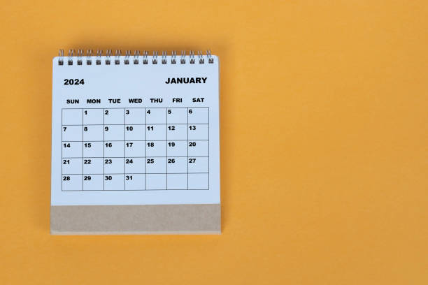 istock January 2024 desk calendar on yellow background. Directly above. Flat lay. 1784093305