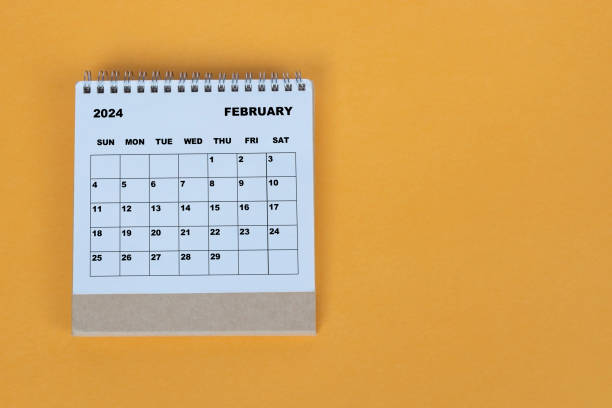 istock February 2024 desk calendar on yellow background. Directly above. Flat lay. 1784093310
