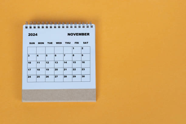 istock November 2024 desk calendar on yellow background. Directly above. Flat lay. 1784095580